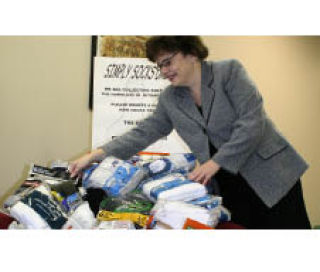 Angela Sell piles the socks collected by local Kiwanis clubs.