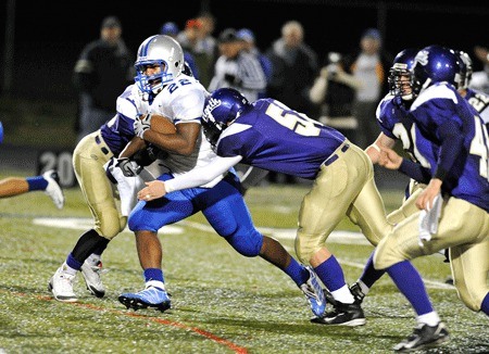 Olympic High School senior Larry Dixon breaks a tackle during a game against North Kitsap High School in 2009.