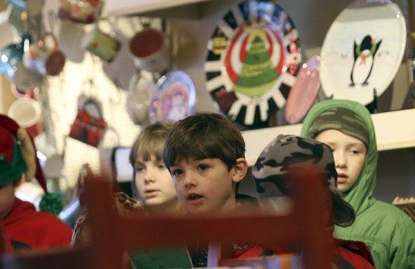 Gateway Christian Schools students sing carols in the Dancing Brush in downtown Poulsbo last week. Local businesses are seeing more customers buying local.