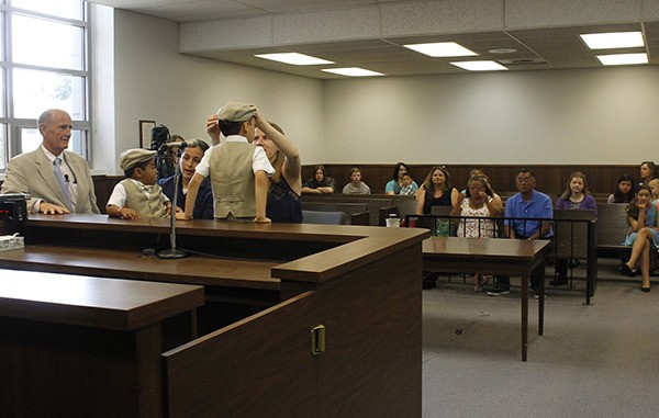 Ashleigh Barraza adjusts her son Isaac's hat prior to their adoption proceedings.