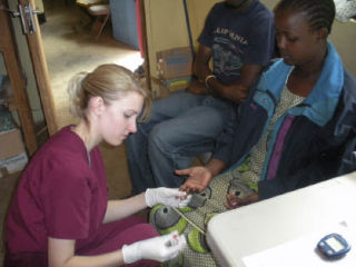 Miss Kitsap 2008 Samantha Przybylek provides care to a nomadic African villager during a recent trip to Tanzania.