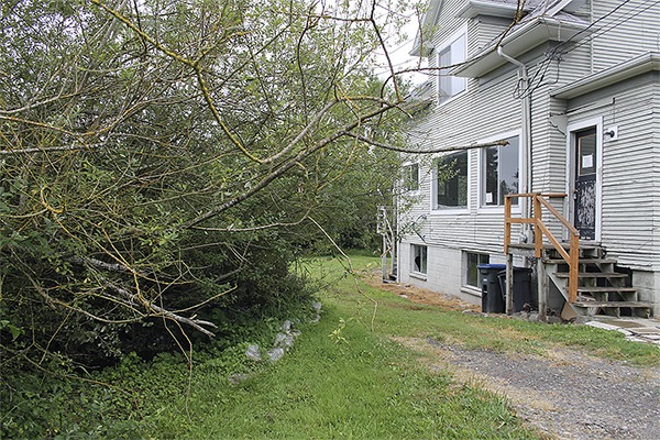 Sandbags and dense vegetation indicate the proximity of Dogfish Creek to the house at 19159 8th Ave. Ruth deMille of Coldwell Banker Bain said the ‘best thing’ would be for the city to acquire the property