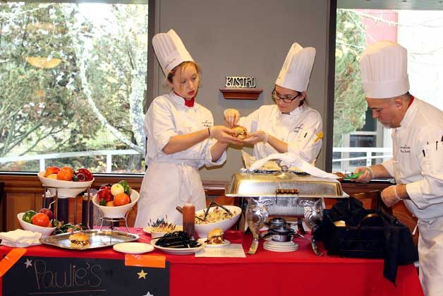 Students prepare barbeque pork sliders to hand out at the Food Truck Brawl Nov. 10. This team came in second place.