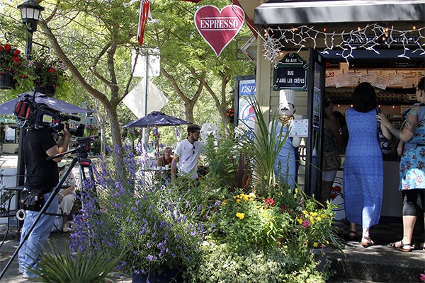 An MTV film crew shoots outside of J'aime Les Crepes in Kingston