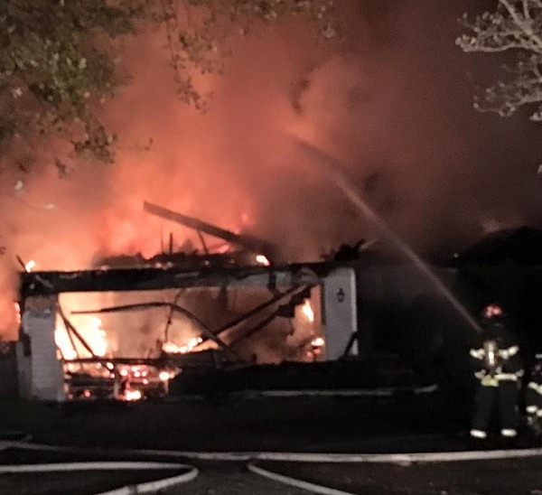 A firefighter battles a house fire off Widme Road near Lincoln Road