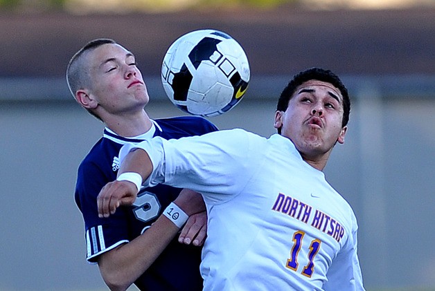 North Kitsap's Marco Lopez goes up for a header against Glacier Peak's Kyle Bjornethum during a first-round state playoff game at North Kitsap Stadium Tuesday. Glacier Peak won the match