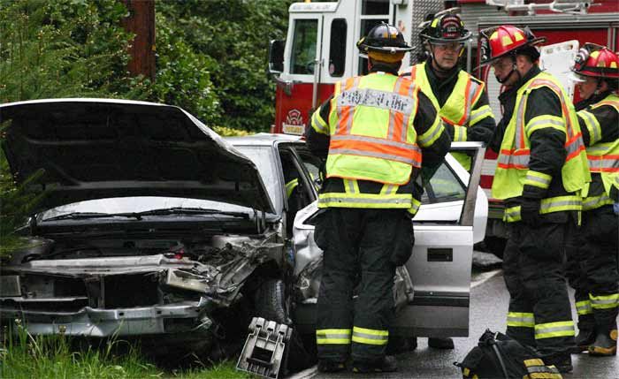 Emergency responders prepare to remove the driver of a Plymouth on NW Finn Hill Road Wednesday afternoon after it collided with a Honda Pilot.