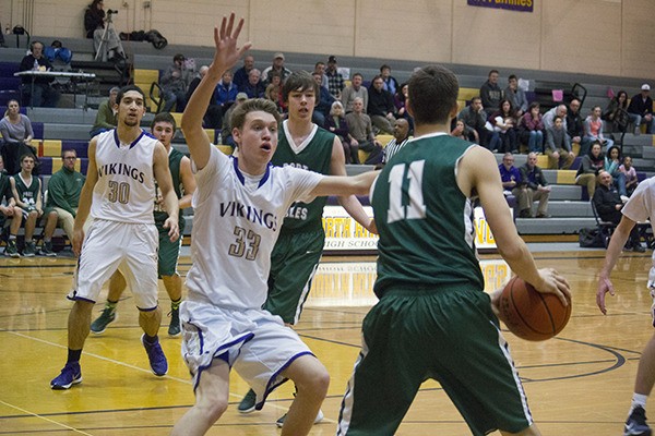 Vikings wing post Evan Waller blocks a pass from Roughrider guard-forward Colton McGuffey in the second half of the Vikings’ home game on Jan. 5.