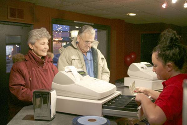 Patrons buy their tickets to see a show at the Historic Orchard Theater -- which has announced it will be closing this week.