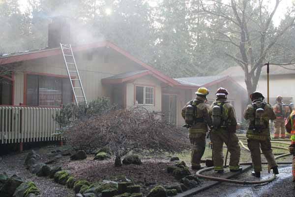 A 78-year-old woman suffered smoke inhalation and her 53-year-old son was burned during a house fire that spread from the kitchen to the attic at the Clear Creek home in Poulsbo Feb. 7.