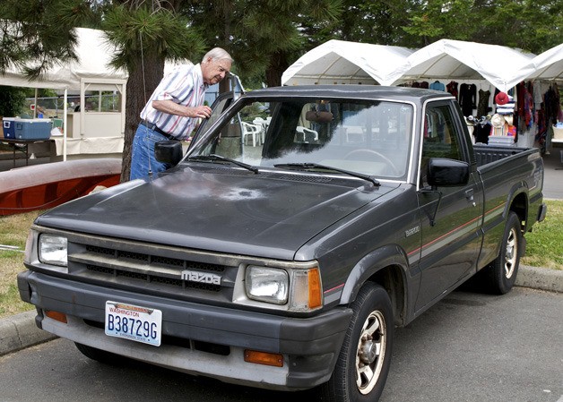 Fred Nelson inspects a pickup that will be auctioned at the Hansville Rummage sale this weekend.
