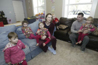 Courtnee and Mike Stevenson with their quints (from left) Scarlett