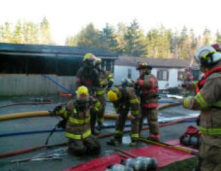 Central Kitsap Fire & Rescue crews at the scene of a fire at Camelot Mobile Estates in Bremerton. Although there have been no reported fire-related deaths in Kitsap County in 2009 so far