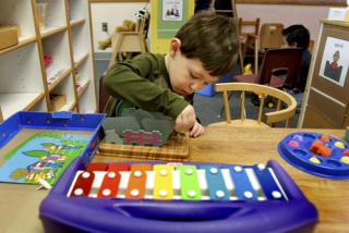 Wolfle preschool student Mack Rienstra solves a puzzle during class Monday at the school.