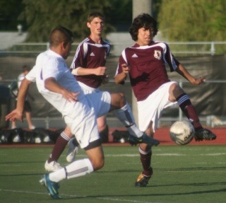 South Kitsap's Diego de la Cruz and Pasco defender converge on the ball during the Wolves 2-1 victory in the Washington State 4A soccer championship match on Saturday night.