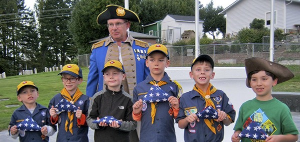 Learning to fold flags  Seven members of Cub Scout Wolf Pack No. 4506 learned flag etiquette on Oct. 16 from Marion (Mick) Hersey