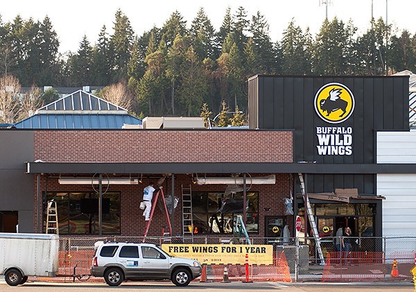 Workers put the finishing touches on a new Buffalo Wild Wings at the Kitsap Mall on Jan. 20.