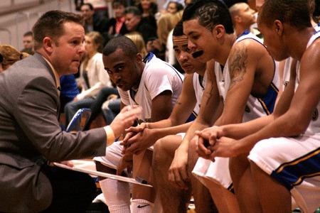 Bremerton High School boys basketball coach Casey Lindberg talks strategy during a timeout Tuesday in the Knights' 72-43 win over Olympic High School.