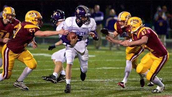 North Kitsap's starting quarterback makes a final attempt at a first down during the Vikings last drive of the Pillage and Plunder Bowl Thursday night against the Kingston High School Buccaneers.