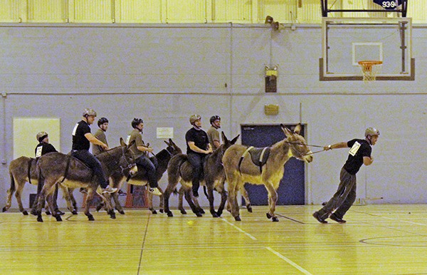 Marine Corps recruiter AJ Russell (22) pulls his donkey