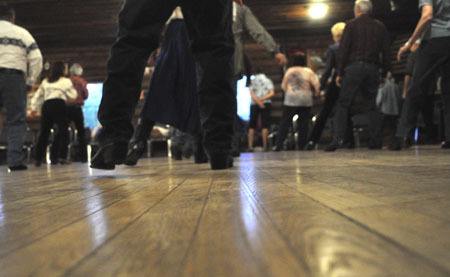 Rows of 'kickers' work the floor at Kitsap Kickers Linedance Club dance at Scout Hall in Silverdale on a recent Friday evening.