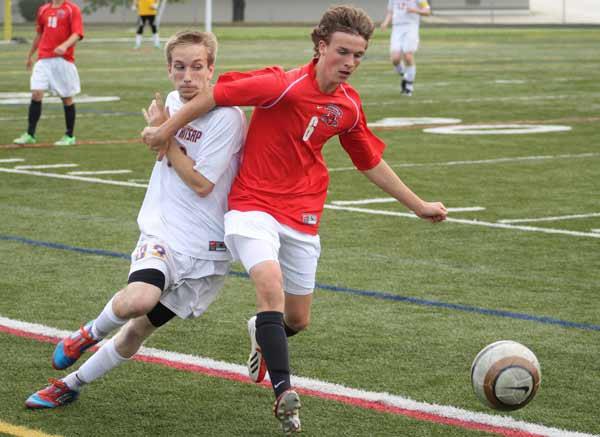 North Kitsap' midfielder Nate Rake battles for possession of the ball during the May 20 state soccer game at North Kitsap Stadium.