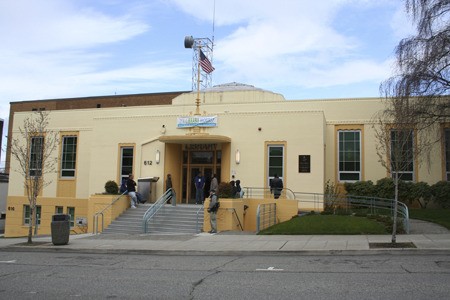 Library patrons wait outside the downtown Bremerton library on Fifth Avenue each day before its 1 p.m. opening.