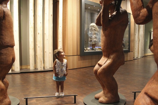 Lilia Cruz of Suquamish dances around the canoe sculpture in the new Suquamish Museum.