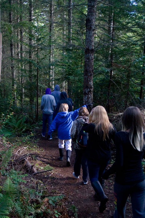 Julie Turk takes her environmental science class on a hike through the Newberry Hill Heritage Park on Friday.