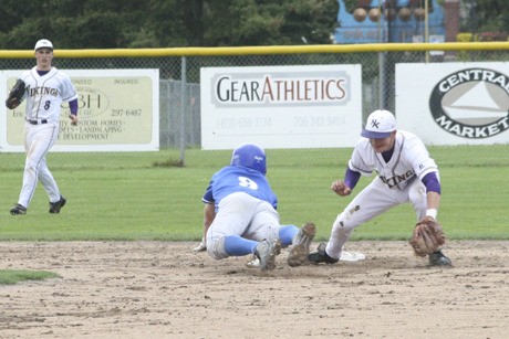 North Kitsap shortstop Zac Smit prepares to tag an Olympic High base runner at second base.