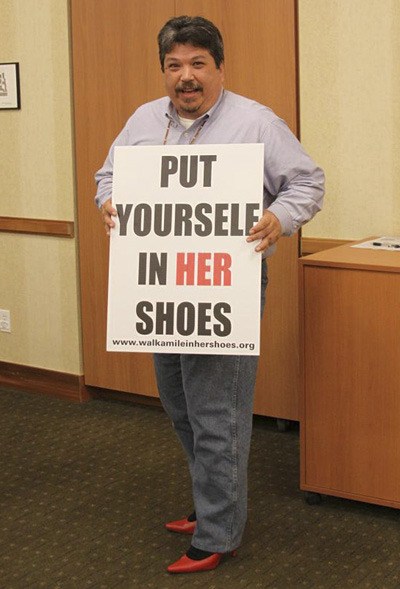 Suquamish Tribal Councilman Jay Mills sports some red heels to support “Walk a Mile In Her Shoes