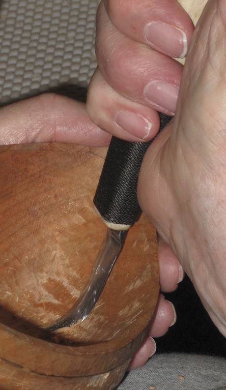 Kitsap woodcarver Gene Gregory gouges into shape a priest bowl