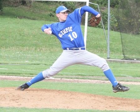 Olympic High School senior Riley Crow throws a pitch during the Trojans' 3-0 loss to North Kitsap High School on Wednesday.