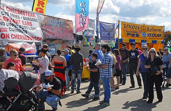 Festival goers stroll near a few of some of the many food vendor stands on Sept. 7.