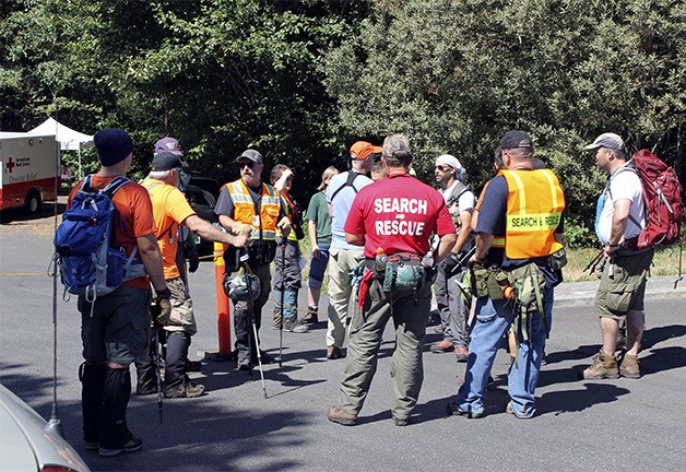 Search and rescue crews receive a briefing at Station 41 before heading out to search for Jenise Wright