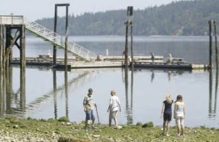 Children walk along the beach at Illahee State Park. Illahee is one of several state parks that will remain open thanks to a donation program created by the Legislature. Vehicle owners can donate $5 to keep parks open when renewing their vehicle license tabs.