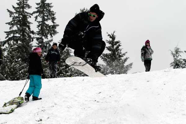 Kingston resident Tim Kinkade performs a board grab after launching off a jump near the Poulsbo Adventist School.