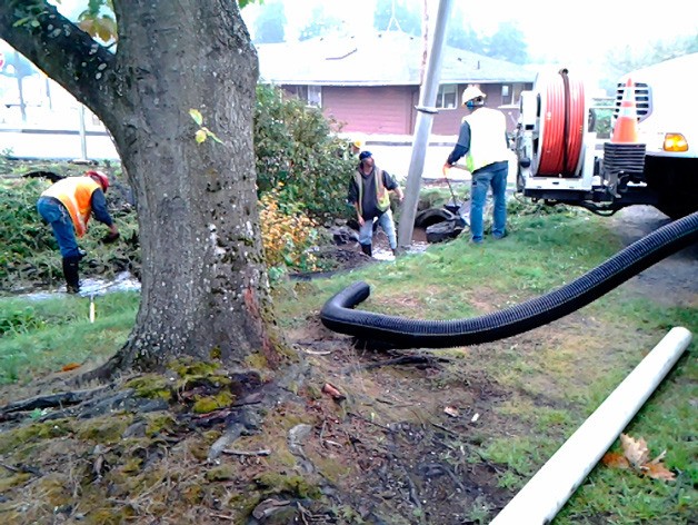 Poulsbo Public Works employees remove detritus to improve the flow of Dogfish Creek at 8th Avenue