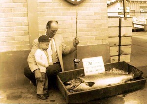 Chet Gausta crouches down next to his state record-setting Chinook salmon