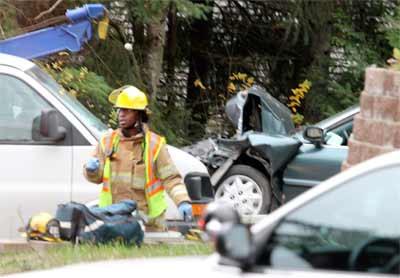 The crumpled front end of a sedan after a car crash on Bond Road. Traffic in the north and south bound lanes were forced to alternate around the scene.