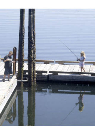 Children fish off the dock at Illahee State Park which is currently on the list of state parks that could be mothballed in an effort to save money.