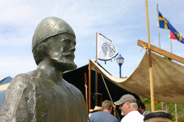 Scandivanian flags flutter above Viking Village and the Viking sculpture dedicated in honor of former Poulsbo mayor Maurice Lindvig (1969-1976)