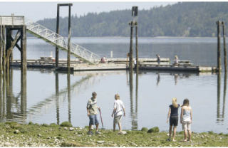 Children walk the shoreline at Illahee State Park which is currently on the list of state parks that could be mothballed in an effort to save money.