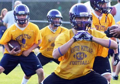 The North Kitsap Vikings football team runs drills during the first day of practice Wednesday.