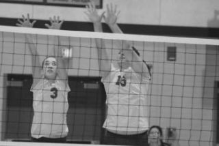 BHS’ Haley Lillybridge (3) and Merissa Duzenski go up for a block during the Lady Knights’ 3-0 victory over Klahowya at home Tuesday. (Below) The team huddles during a timeout.