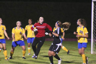 Bremerton goalkeeper Kristy Wood goes up for a save during Klahowya’s 4-2 win in the rain at Memorial Stadium Tuesday.