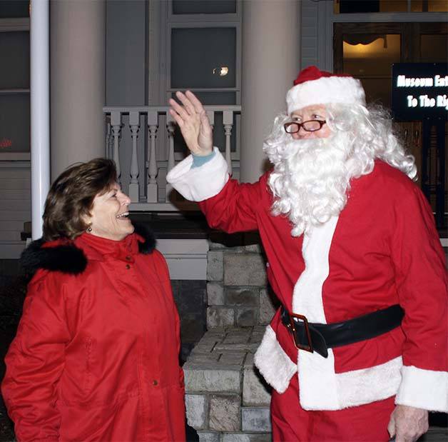 Bremerton Mayor Patty Lent smiles at Santa Claus during a tree lighting ceremony in Bremerton during the city's Winterfest event.