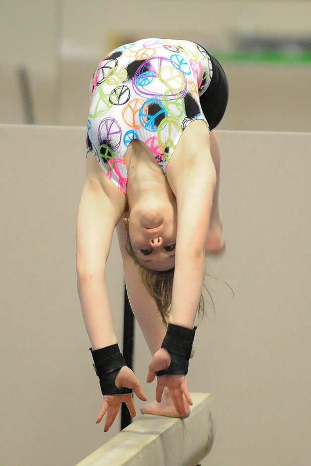 Megan Kelly practices her balance beam routine at the Zero Gravity Gymnasium on Wednesday. Kelly is one of four returning students to the team this season.