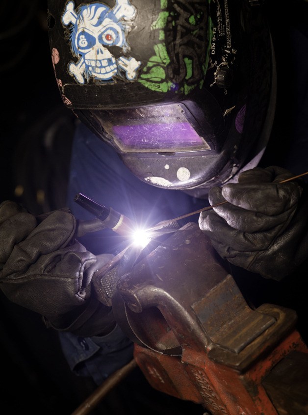 Hull Maintenance Technician 3rd Class Donavon Ferred welds a bracket in the sheet metal shop aboard the Nimitz-class aircraft carrier USS John C. Stennis (CVN 74).