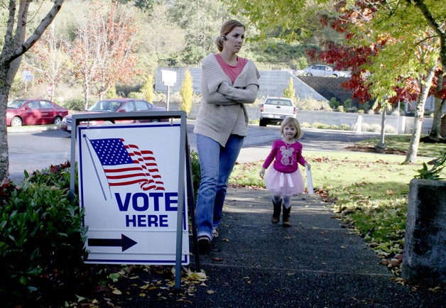 Shannon Meyers and daughter Lindsay-Kate walk to a ballot drop Tuesday at the Poulsbo Fire Department station on Liberty Road.